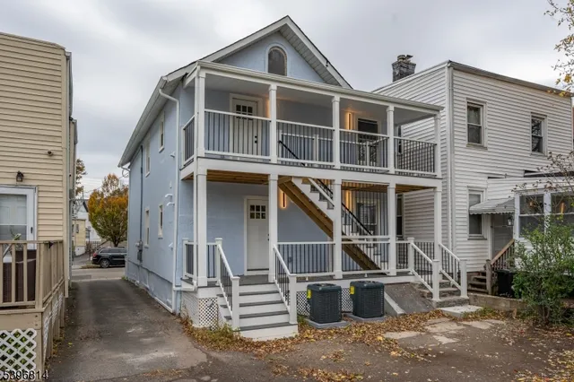 a front view of a house with a street