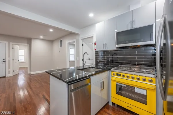 a kitchen that has a sink and a stove in it