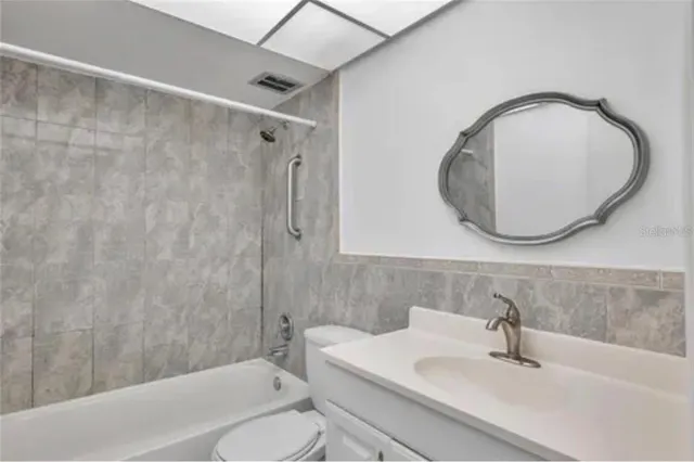 an empty room with wooden floor and closet