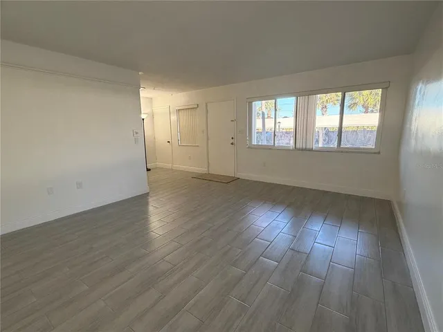 a view of an empty room and wooden floor