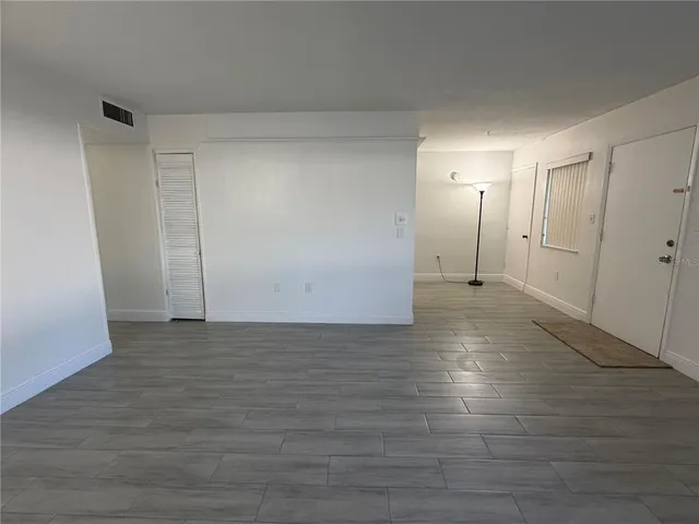 a view of an empty room and wooden floor