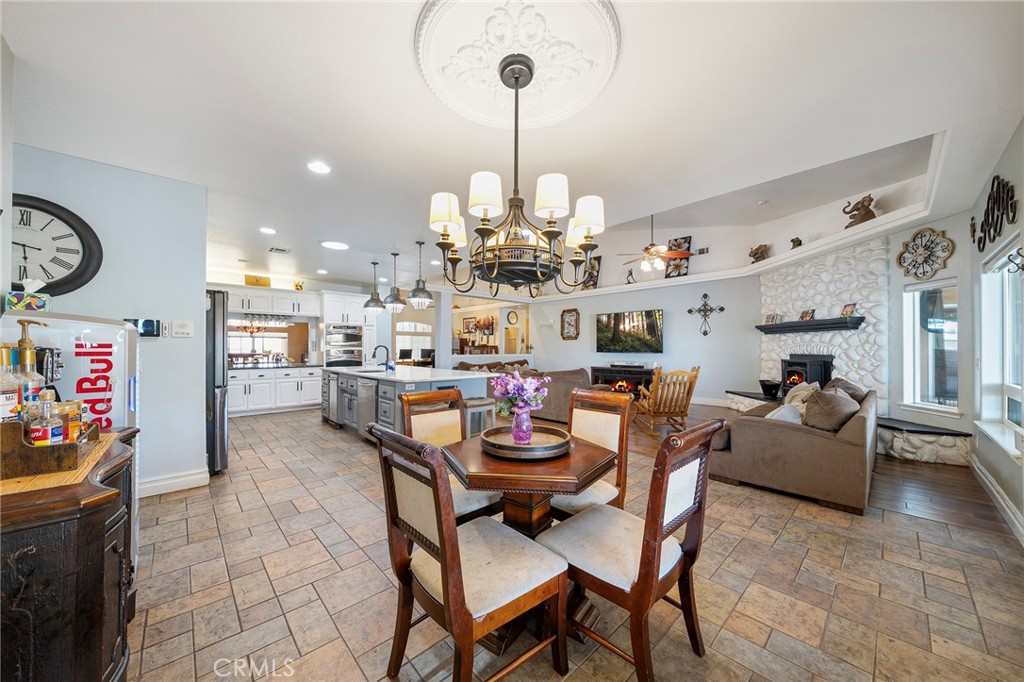 7172 Jargon Road Hesperia, CA 92344 - Photo 22 of 75 a view of a dining room and livingroom with furniture cabinet and a chandelier