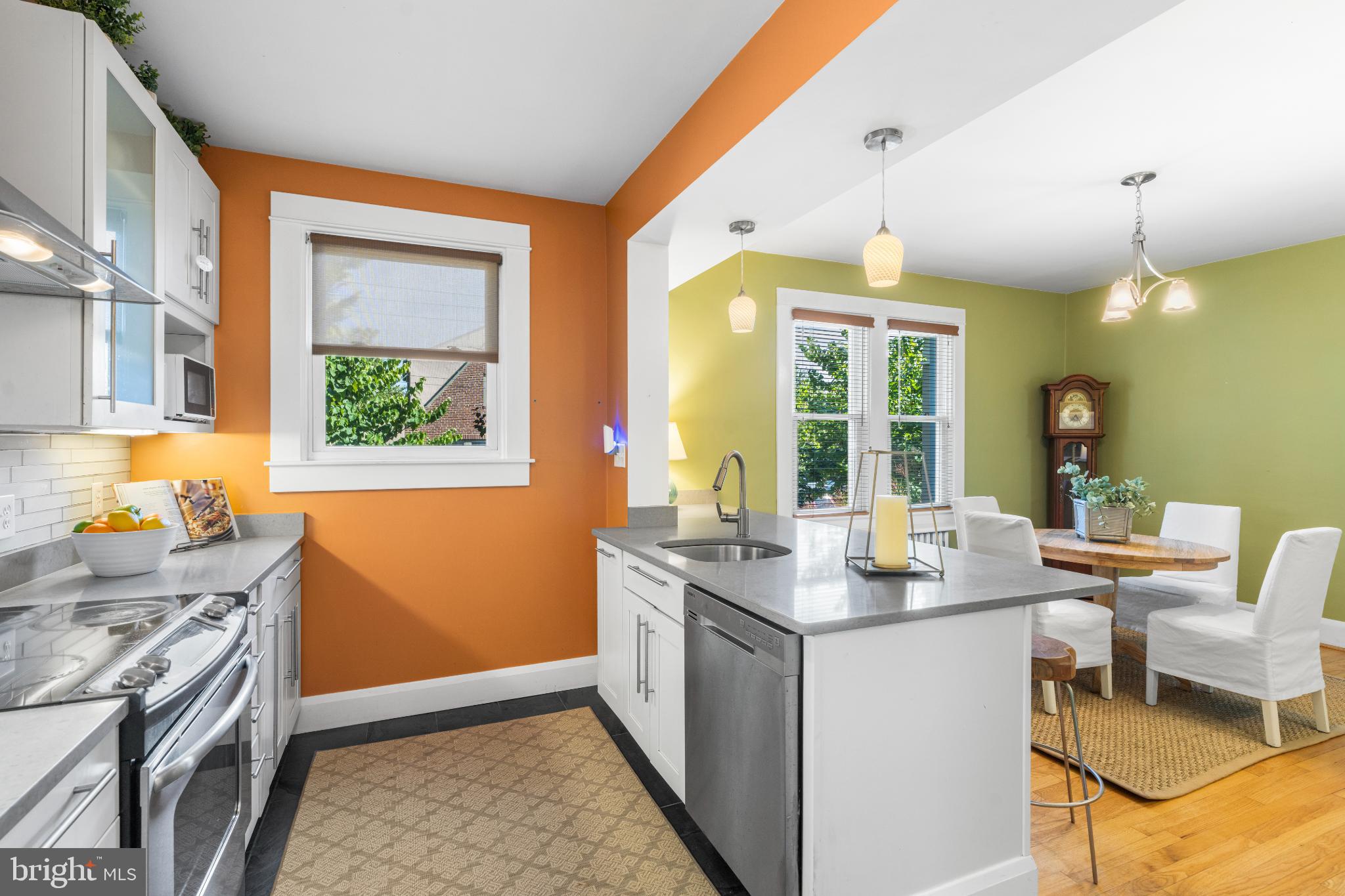 532 Overbrook Road Baltimore, MD 21212 - Photo 17 of 44 a open kitchen with stainless steel appliances granite countertop a stove top oven a sink dishwasher a dining table and chairs with wooden floor