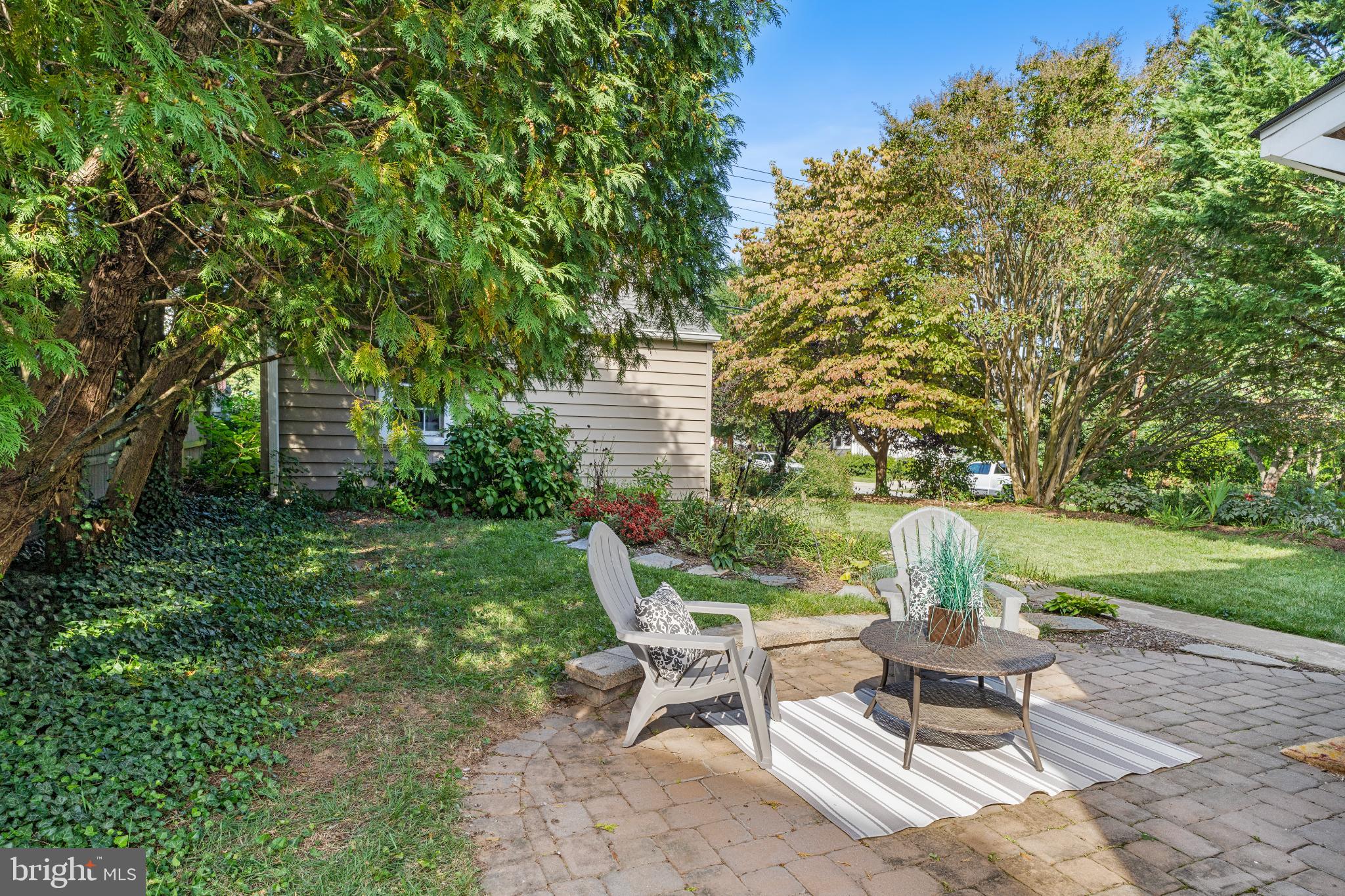 532 Overbrook Road Baltimore, MD 21212 - Photo 37 of 44 a view of a patio with table and chairs and potted plants and large trees