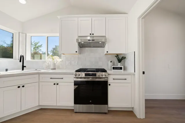 a kitchen with a stove and a sink