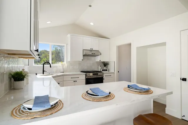 a kitchen with sink and refrigerator