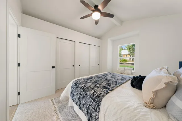 a bedroom with a bed and a window