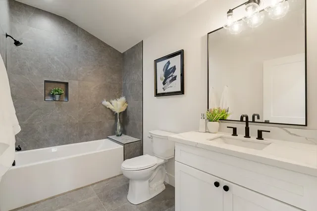 a bathroom with a sink a toilet and a bathtub