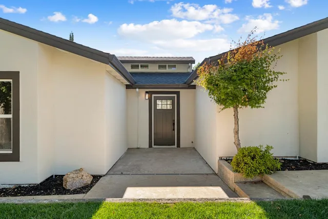 a front view of a house with garden