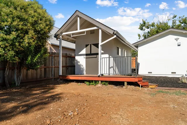 a front view of house with wooden fence