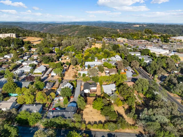 an aerial view of residential houses with outdoor space