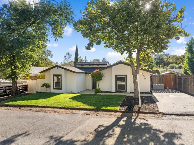 an aerial view of a house with a yard