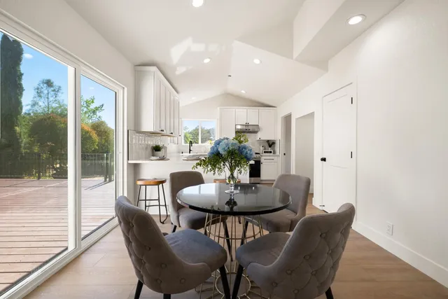 a view of a dining room with furniture and a potted plant