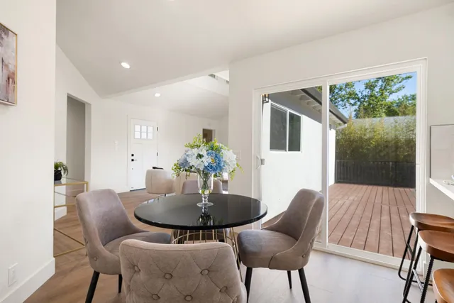 a dining room with furniture and wooden floor