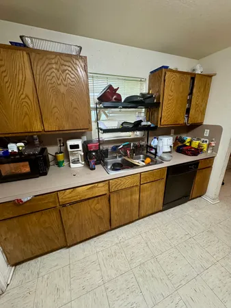 a kitchen with stainless steel appliances a sink and cabinets