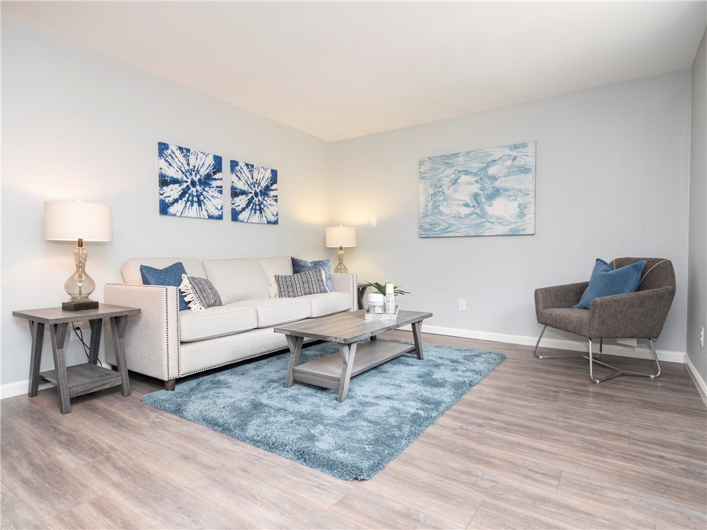 7004 Circle S Road, Unit B Austin, TX 78745 - Photo 7 of 12 Relax in a cozy living room featuring sleek hardwood flooring and a comfortable sofa, perfect for unwinding.