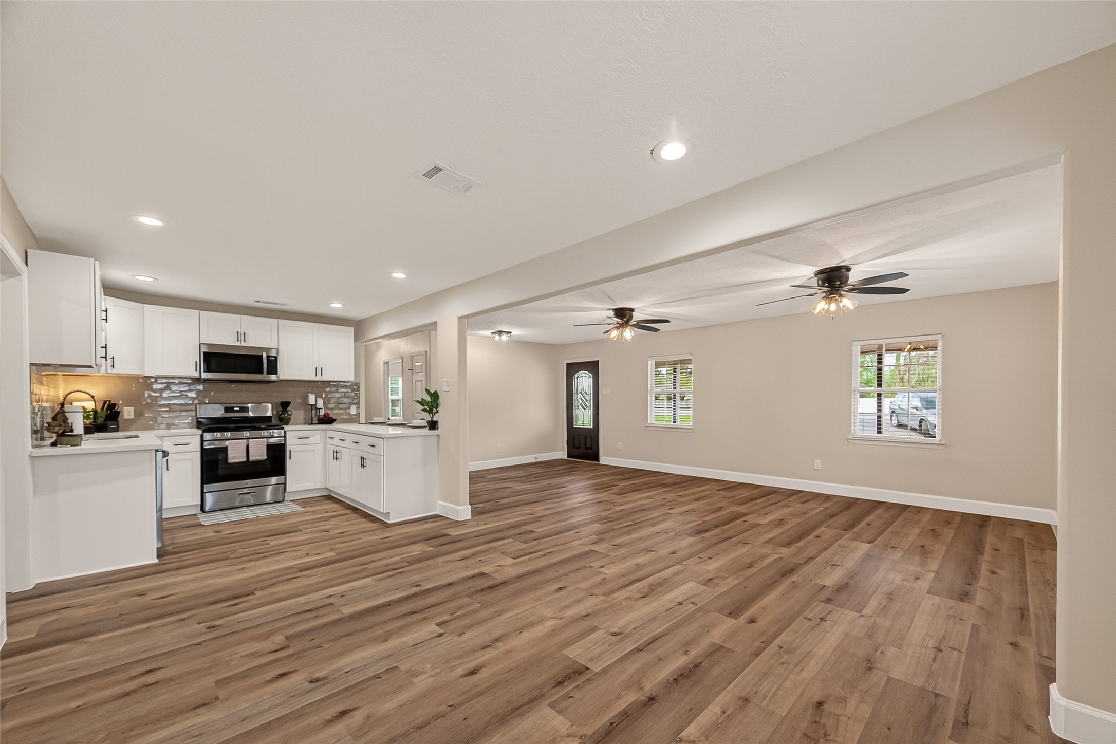 917 South Main Street Highlands, TX 77562 - Photo 11 of 45 a view of kitchen with wooden floor and electronic appliances