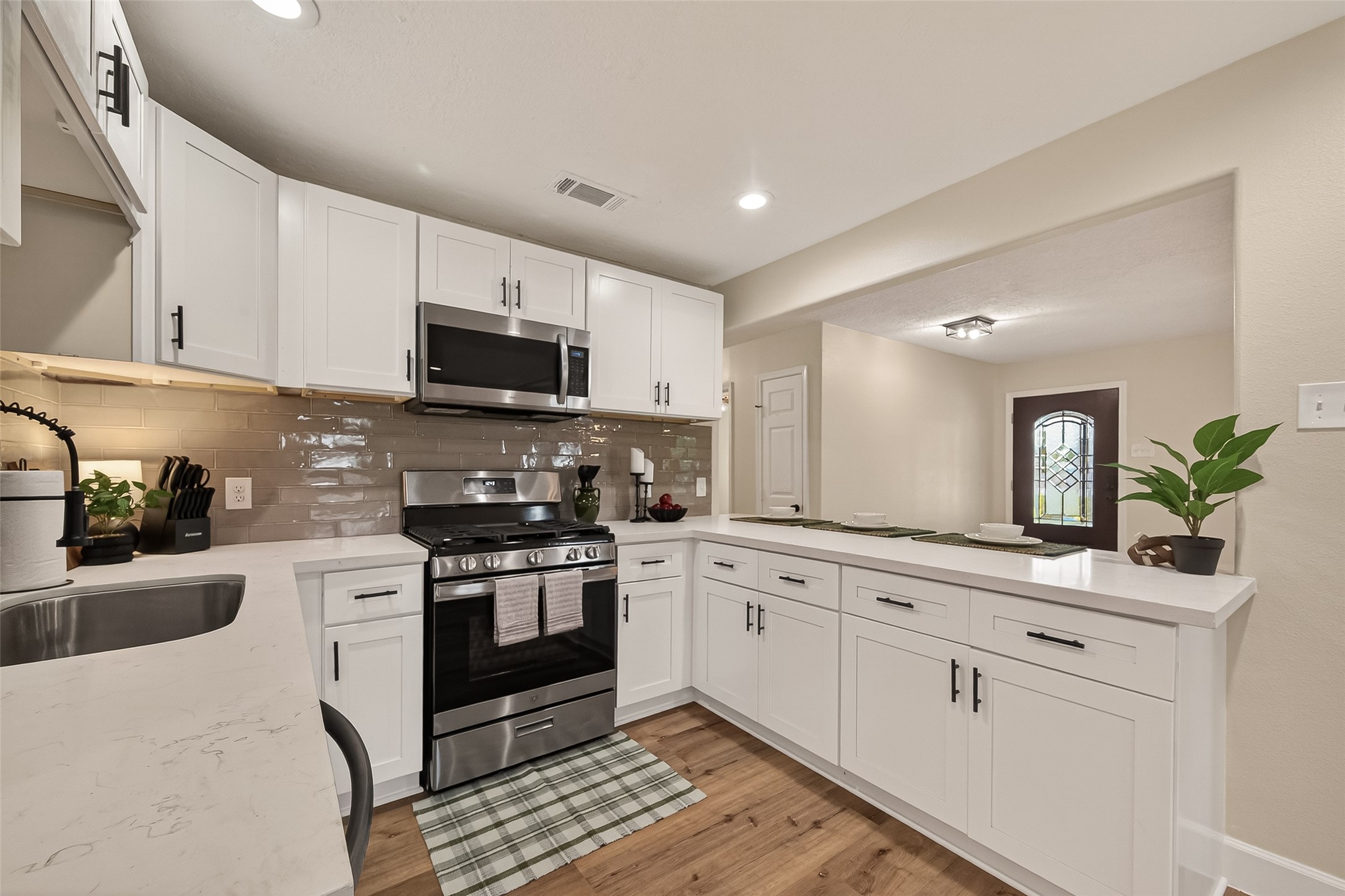 917 South Main Street Highlands, TX 77562 - Photo 15 of 45 a kitchen with granite countertop white cabinets and stainless steel appliances