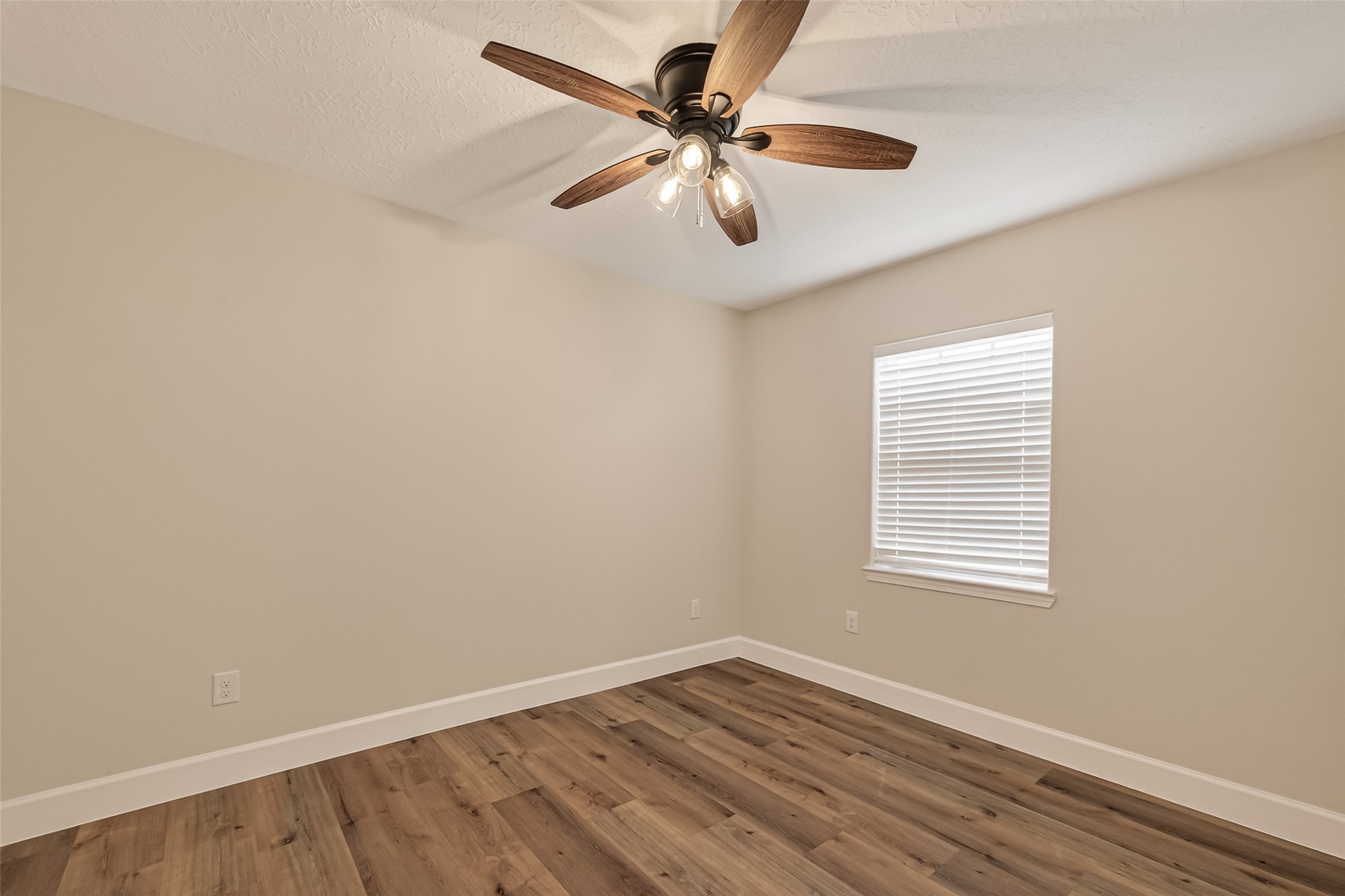 917 South Main Street Highlands, TX 77562 - Photo 18 of 45 an empty room with wooden floor and windows