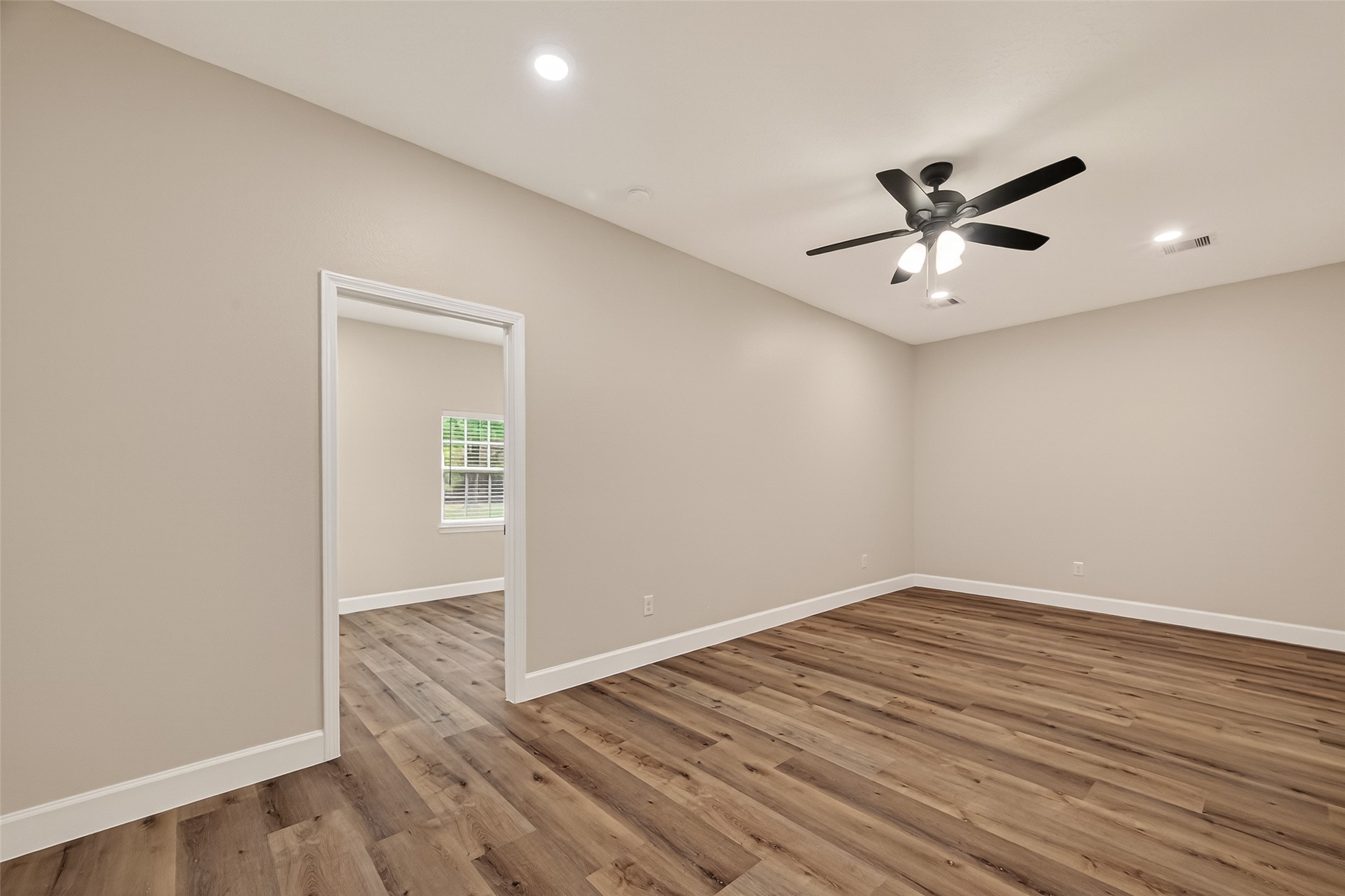 917 South Main Street Highlands, TX 77562 - Photo 24 of 45 wooden floor in an empty room with a window