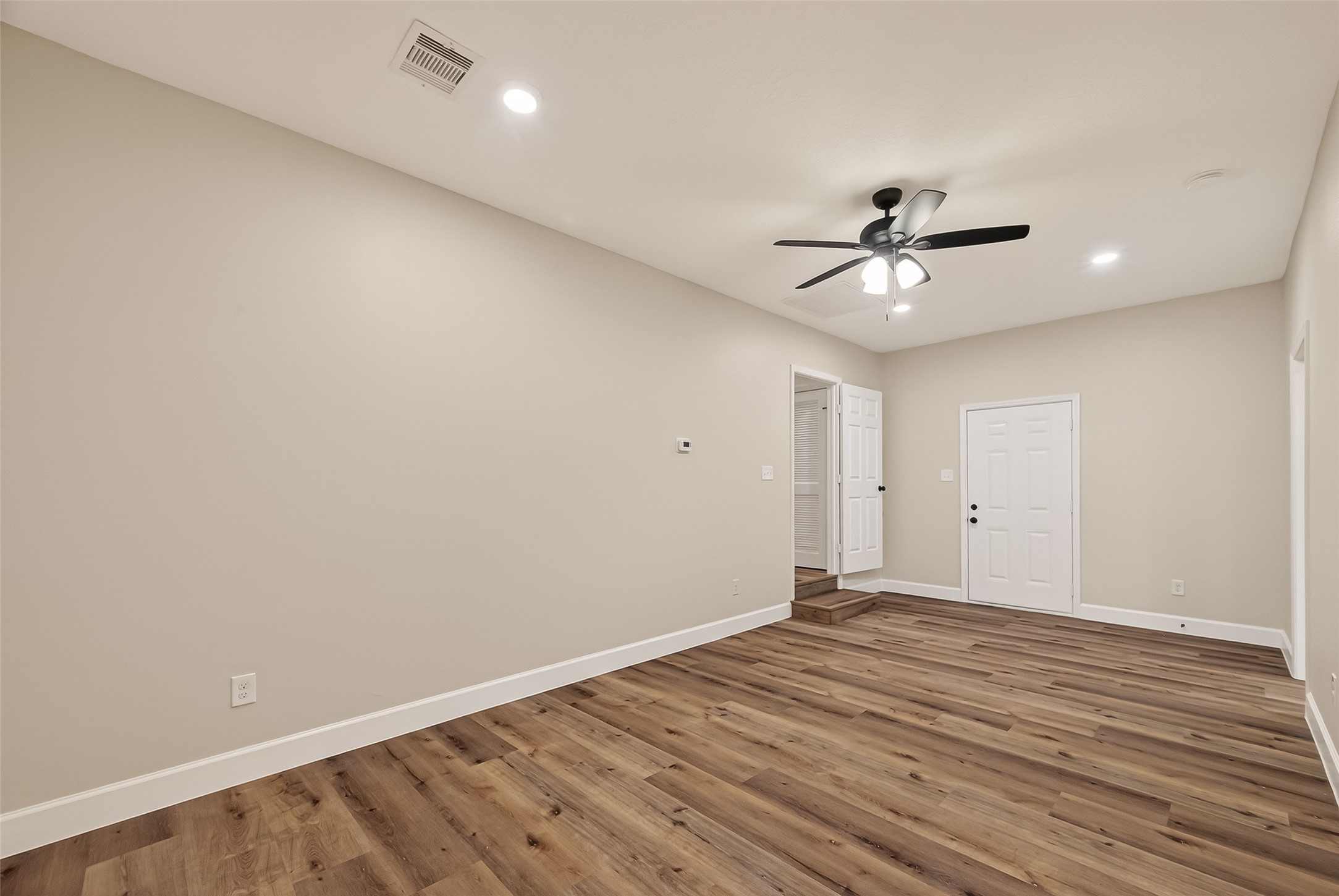 917 South Main Street Highlands, TX 77562 - Photo 26 of 45 wooden floor in an empty room with a fan