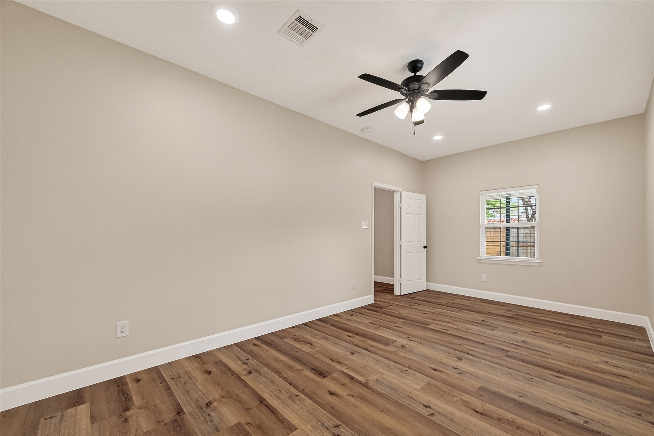 917 South Main Street Highlands, TX 77562 - Photo 29 of 45 wooden floor in an empty room with a window