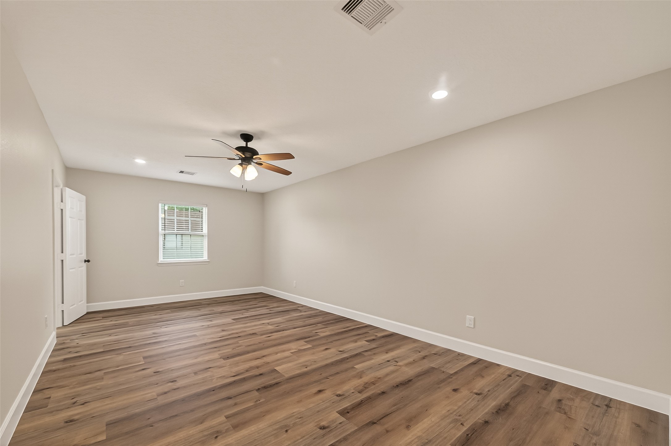 917 South Main Street Highlands, TX 77562 - Photo 30 of 45 wooden floor in an empty room with a window