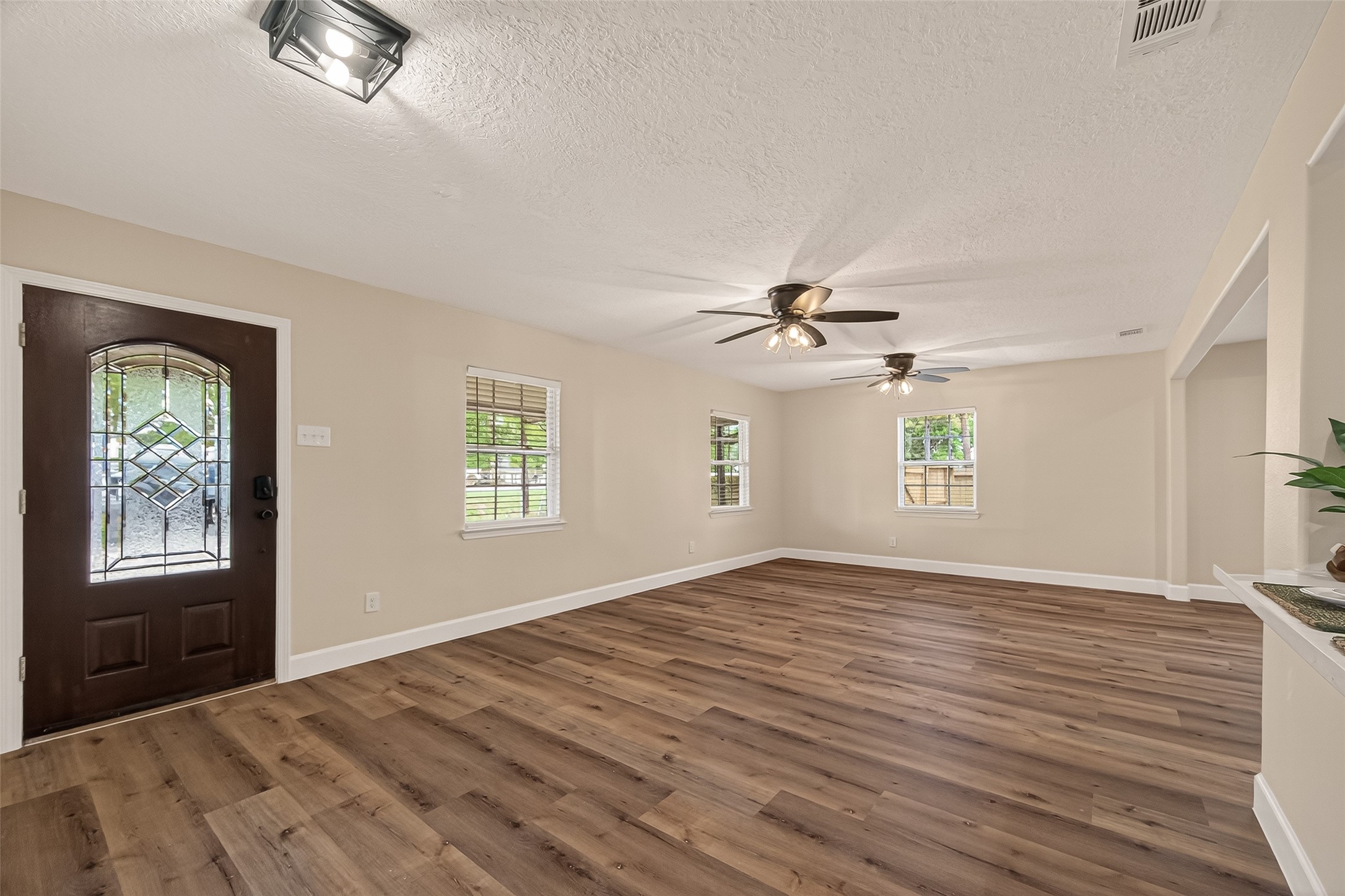 917 South Main Street Highlands, TX 77562 - Photo 4 of 45 a view of empty room with wooden floor and fan