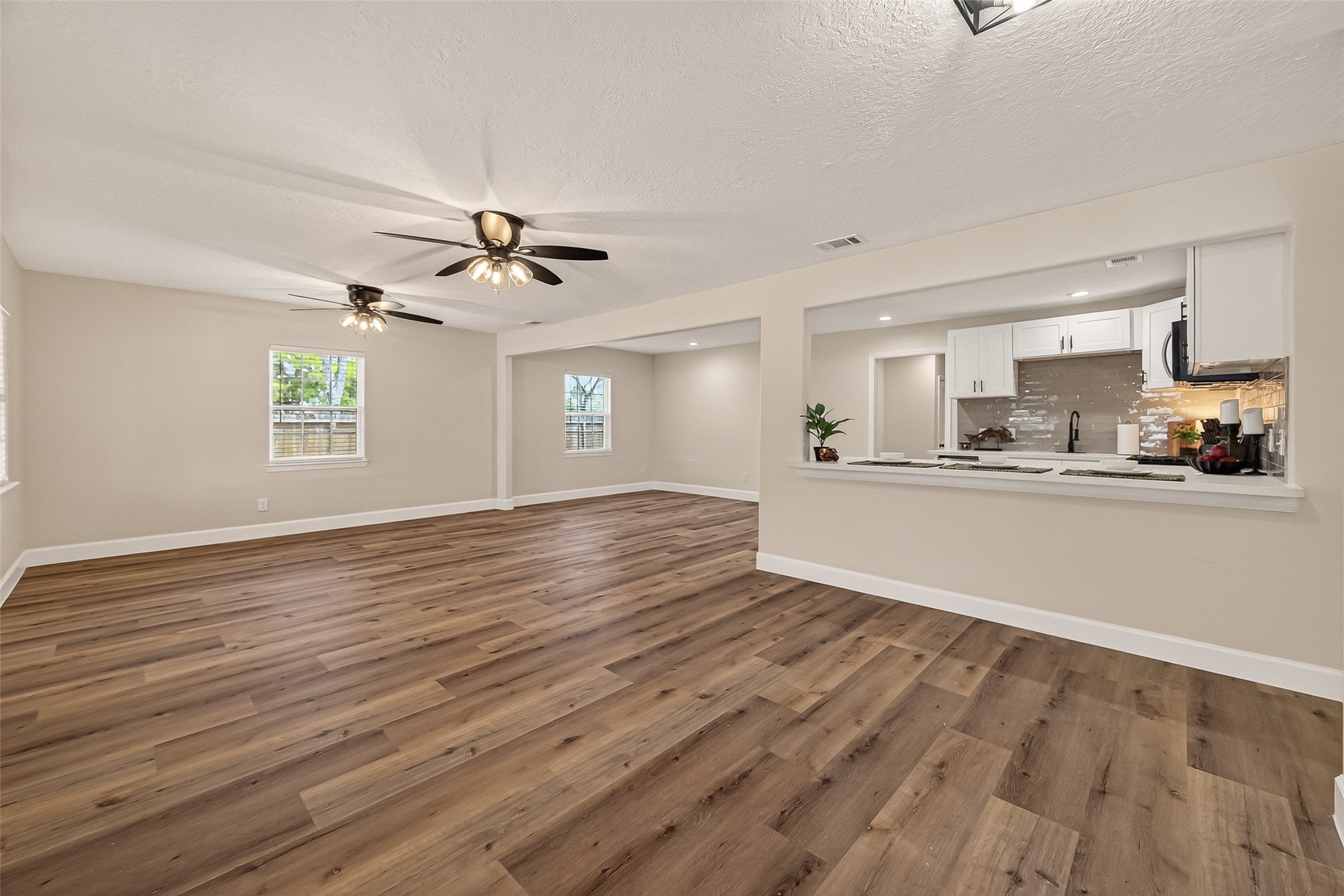 917 South Main Street Highlands, TX 77562 - Photo 5 of 45 a view of a kitchen with wooden floor and a window
