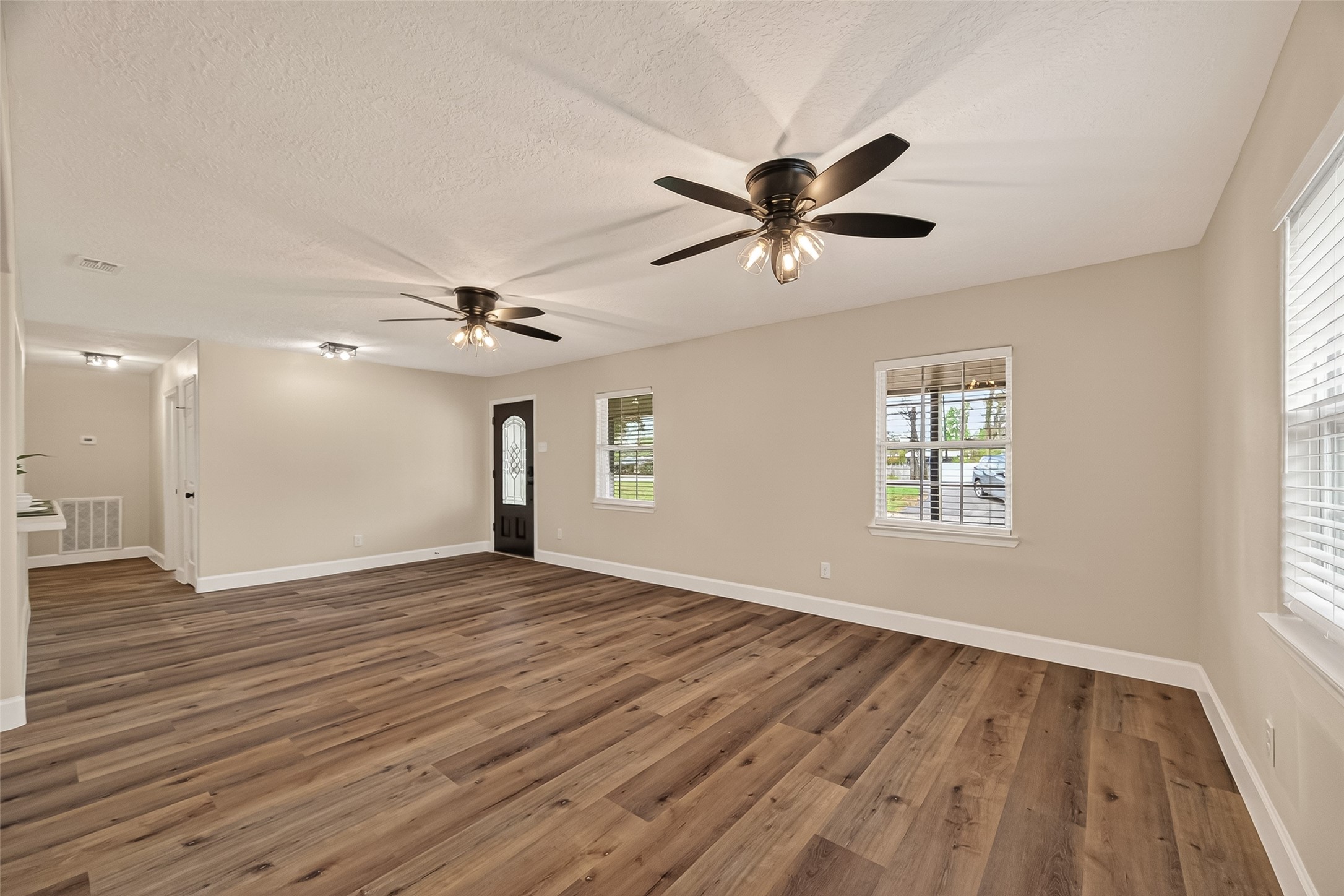 917 South Main Street Highlands, TX 77562 - Photo 7 of 45 a view of empty room with wooden floor and fan