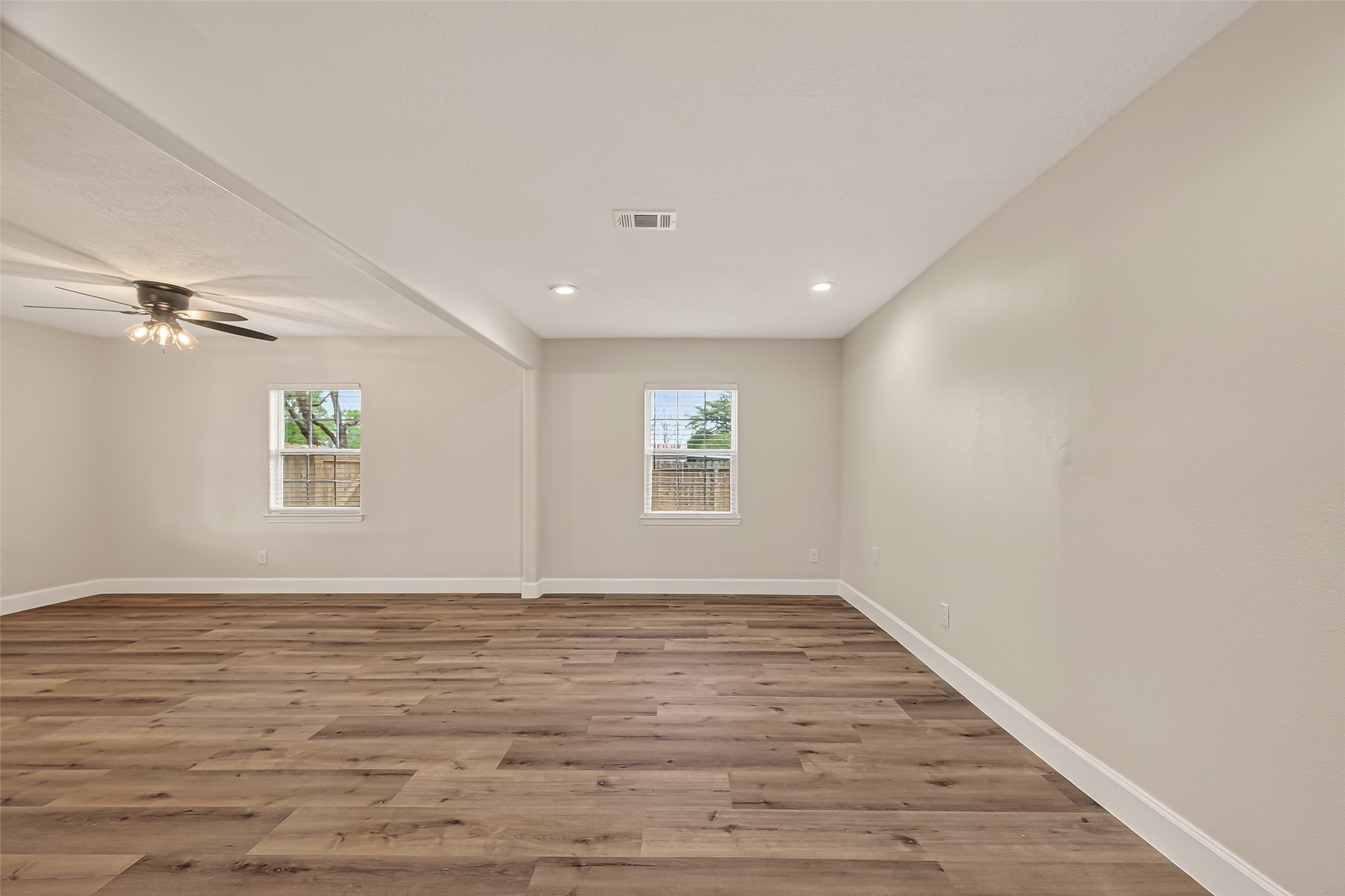 917 South Main Street Highlands, TX 77562 - Photo 9 of 45 an empty room with wooden floor and windows