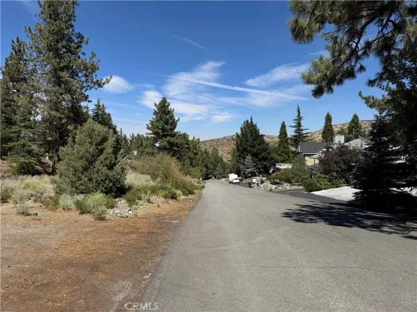 a street view with a car parked on the side of the road