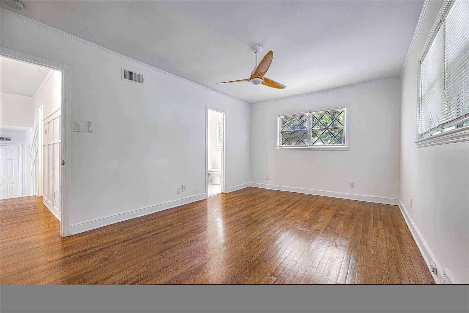 3121 East Glengarry Road Memphis, TN 38128 - Photo 14 of 15 a view of an empty room with wooden floor and a window