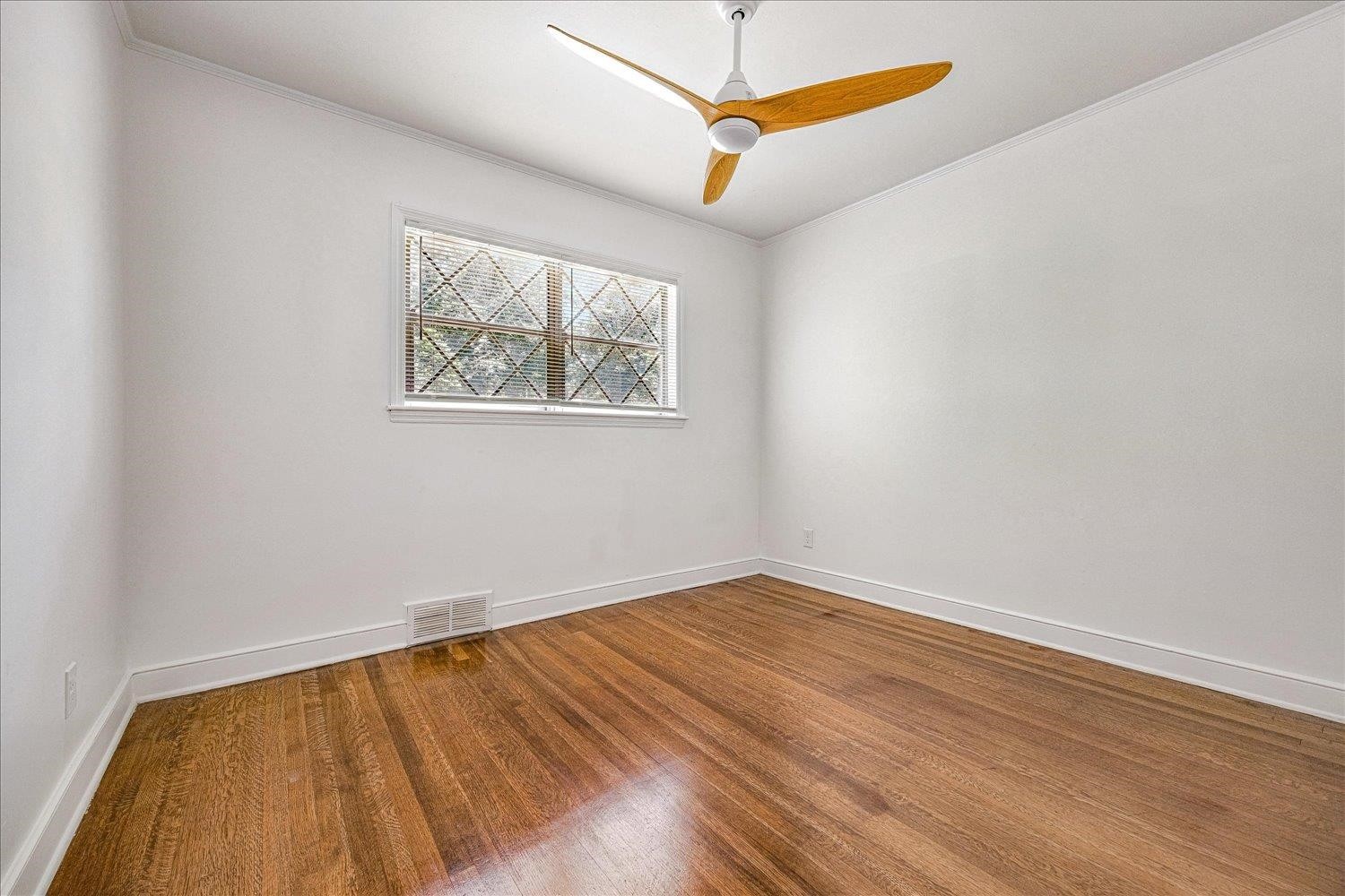 3121 East Glengarry Road Memphis, TN 38128 - Photo 9 of 15 a view of an empty room with wooden floor and a ceiling fan