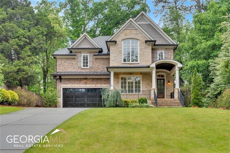 a front view of a house with a yard and garage
