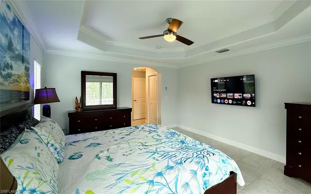 a bedroom with a bed and a chandelier