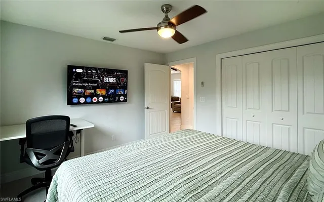 a bedroom with a bed and a chair