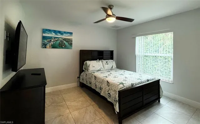 a bed sitting in a bedroom next to a window