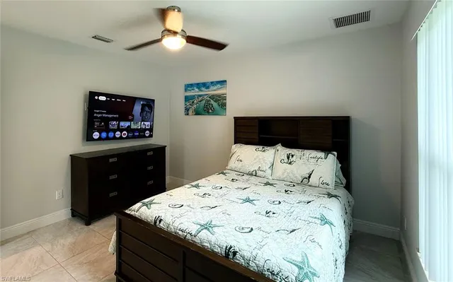 a bed sitting in a bedroom and a chandelier