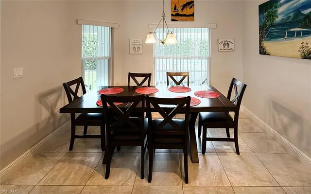 a view of a dining room with furniture and window