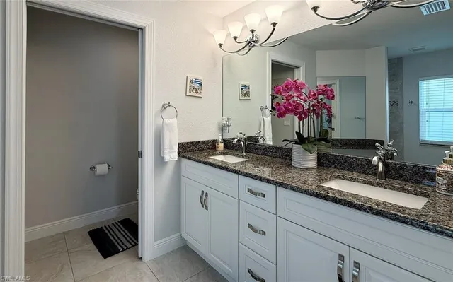 a bathroom with a granite countertop sink a large mirror and a shower
