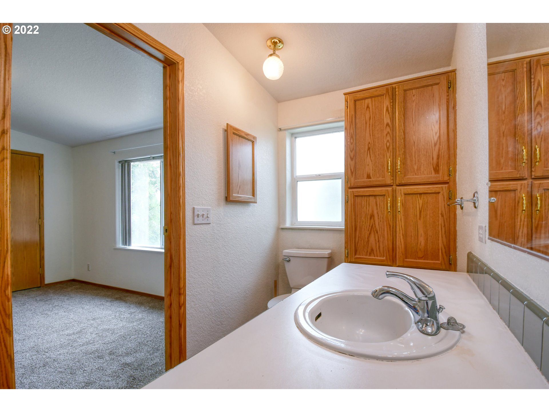 2600 Southwest Goodwin Avenue, Unit 33 Pendleton, OR 97801 - Photo 19 of 29 a bathroom with a sink toilet and mirror
