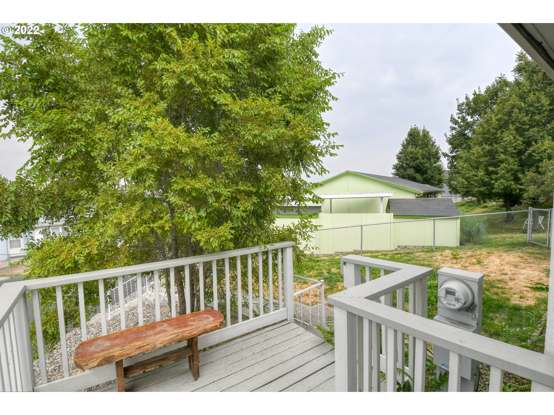 2600 Southwest Goodwin Avenue, Unit 33 Pendleton, OR 97801 - Photo 5 of 29 a view of a wooden deck and a yard