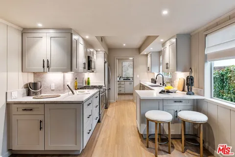 a kitchen with stainless steel appliances a sink and cabinets