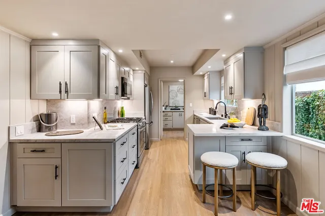 a kitchen with stainless steel appliances a sink and cabinets