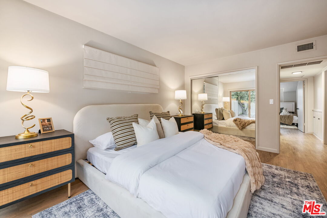 15115 Gilmore Street Van Nuys, CA 91411 - Photo 17 of 26 a bedroom with bed and a lamp on table