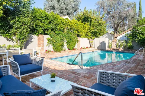 a view of a backyard with sitting area