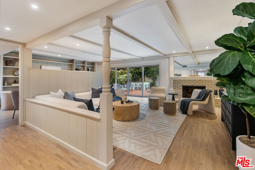 15115 Gilmore Street Van Nuys, CA 91411 - Photo 4 of 26 a living room with furniture and a fireplace