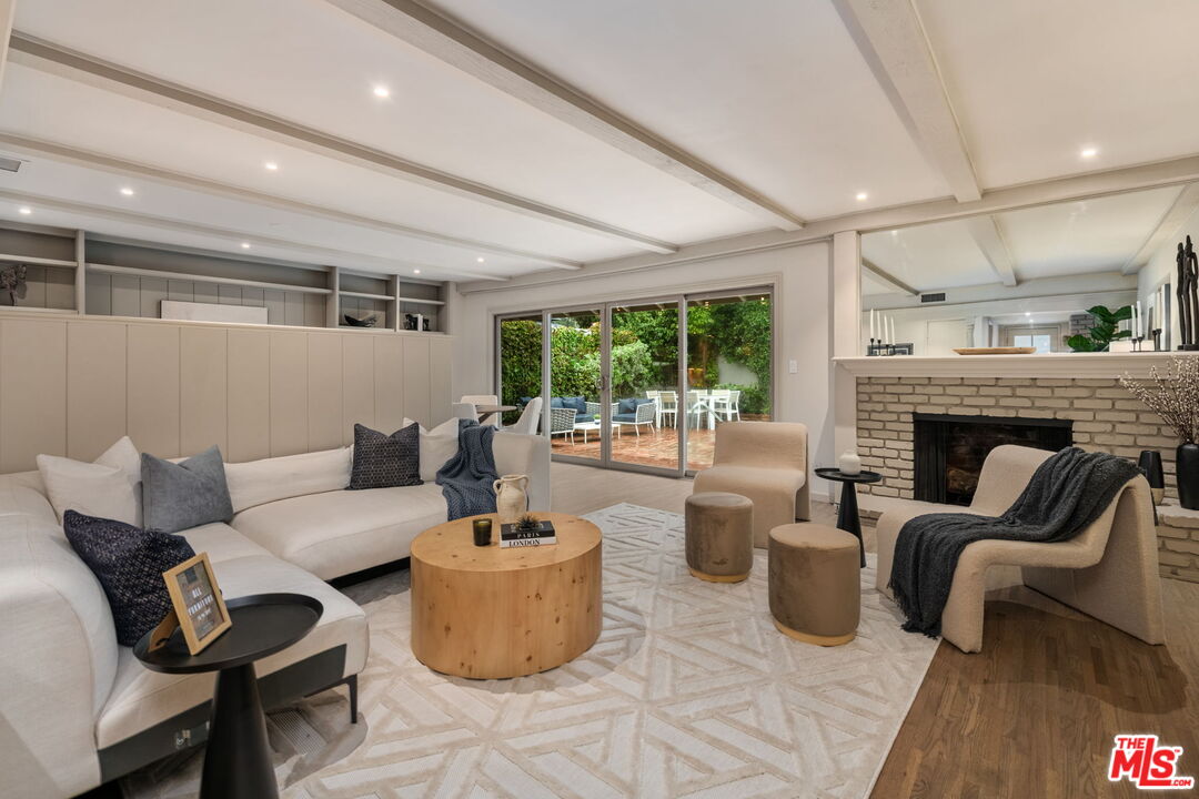 15115 Gilmore Street Van Nuys, CA 91411 - Photo 5 of 26 a living room with furniture and a fireplace