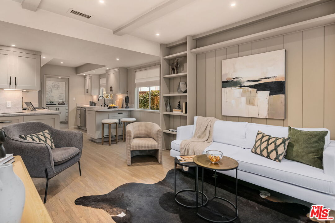 15115 Gilmore Street Van Nuys, CA 91411 - Photo 9 of 26 a living room with furniture wooden floor and a large window